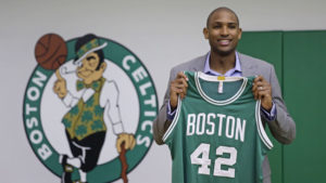 Boston Celtics forward Al Horford holds up a jersey during a media availability at the team's practice facility, Friday, July 8, 2016, in Waltham, Mass. Horford agreed to a four-year, $113 million deal with the Celtics as an unrestricted free agent, ending nearly ten years with the Atlanta Hawks. (AP Photo/Charles Krupa)